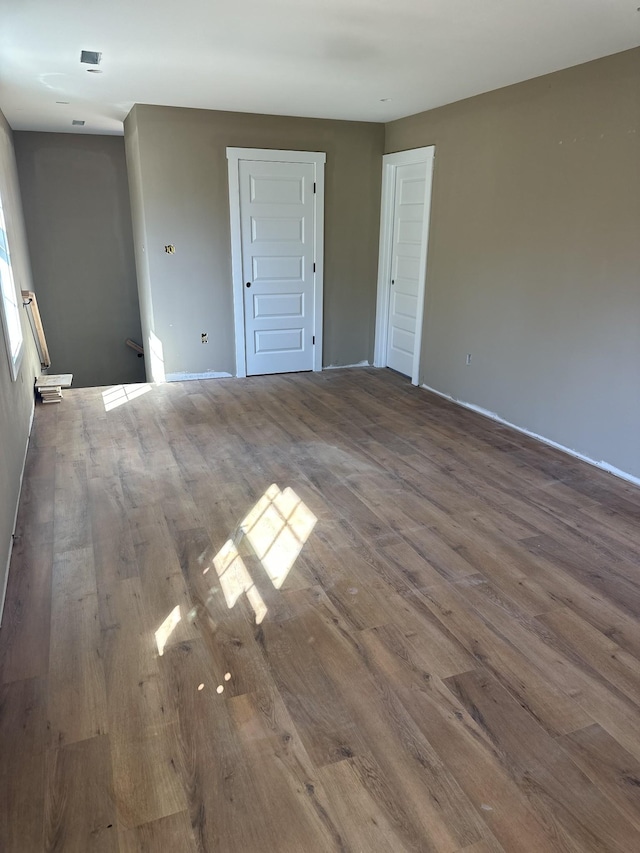 spare room featuring visible vents and wood finished floors