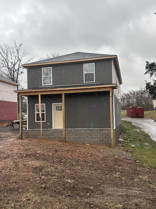 view of front facade featuring covered porch and a hot tub