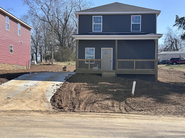 view of front of property with a porch and roof with shingles