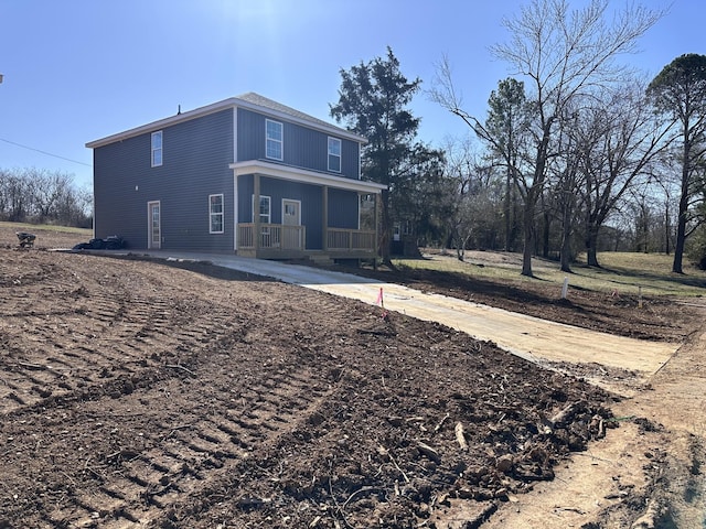 back of house featuring a porch