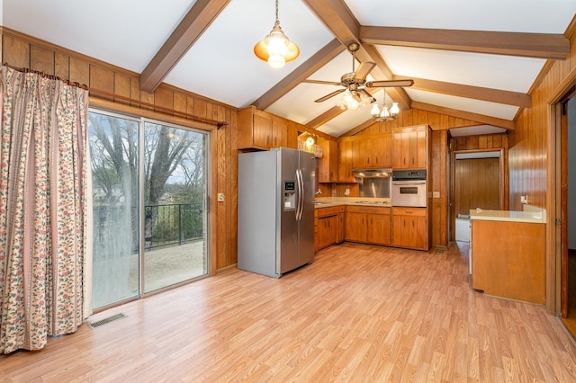 kitchen with wall oven, light hardwood / wood-style flooring, lofted ceiling with beams, stainless steel refrigerator with ice dispenser, and wooden walls