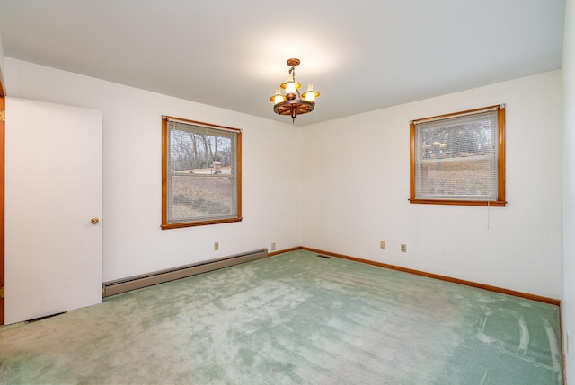 carpeted spare room featuring a chandelier and a baseboard radiator