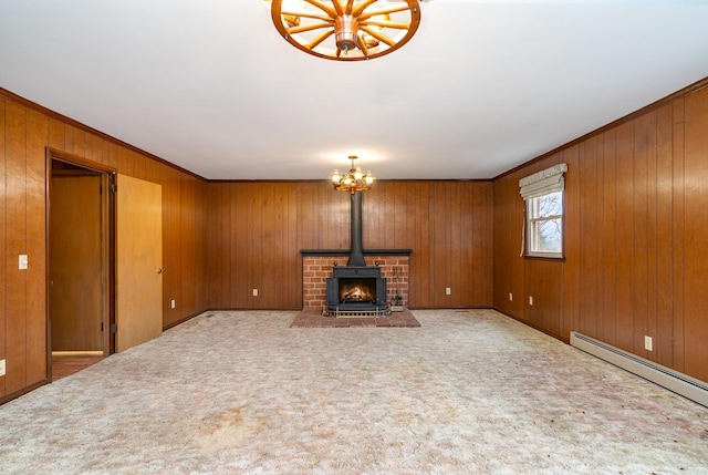 unfurnished living room with a chandelier, crown molding, wooden walls, and a baseboard radiator