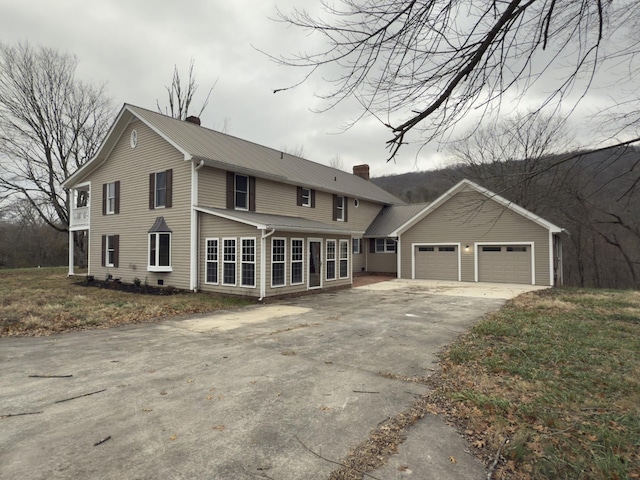 view of front of home with an outdoor structure and a garage