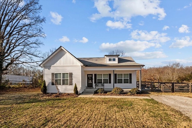 view of front facade with covered porch and a front lawn