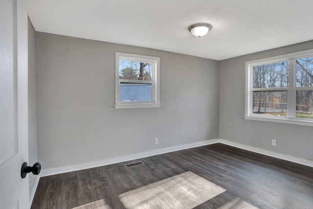 spare room with dark wood-type flooring