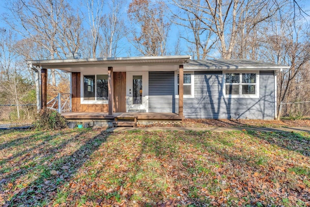 single story home with covered porch and a front yard