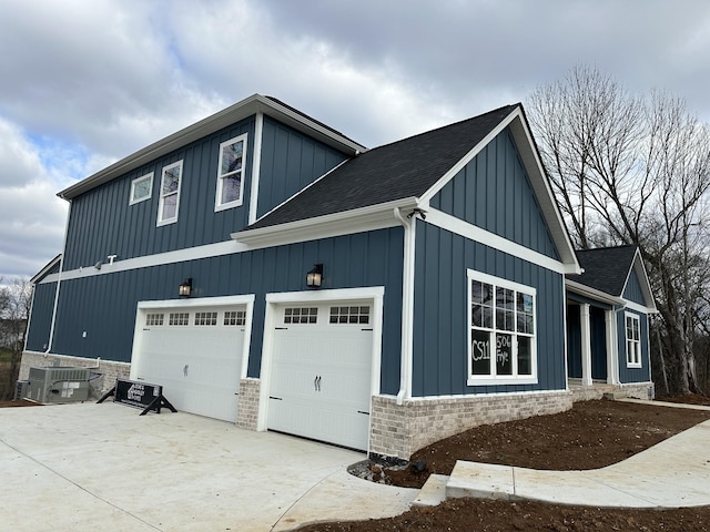 view of home's exterior with central AC unit and a garage