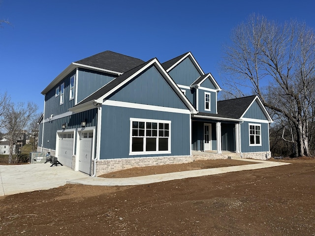 craftsman-style home with a porch and a garage