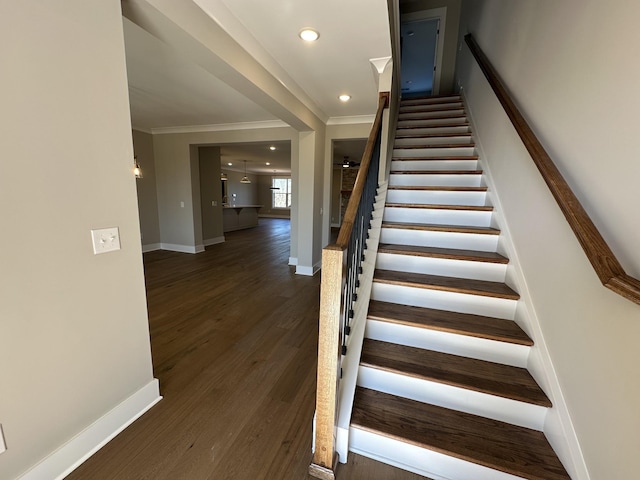 stairway featuring ornamental molding and hardwood / wood-style floors