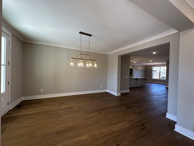 unfurnished dining area featuring ornamental molding, a chandelier, and dark hardwood / wood-style floors