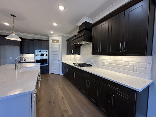 kitchen featuring sink, light stone counters, decorative backsplash, dark hardwood / wood-style floors, and double oven