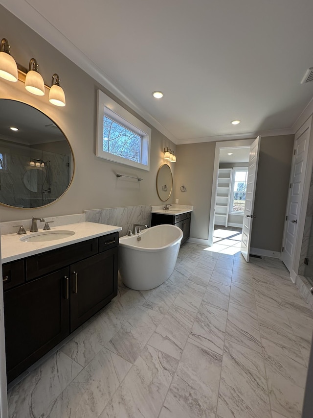 bathroom with vanity, ornamental molding, and independent shower and bath