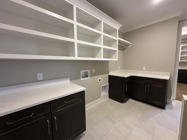 laundry area with electric dryer hookup, hookup for a washing machine, cabinets, and ornamental molding