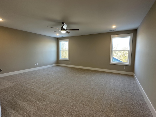 unfurnished room with carpet flooring and ceiling fan