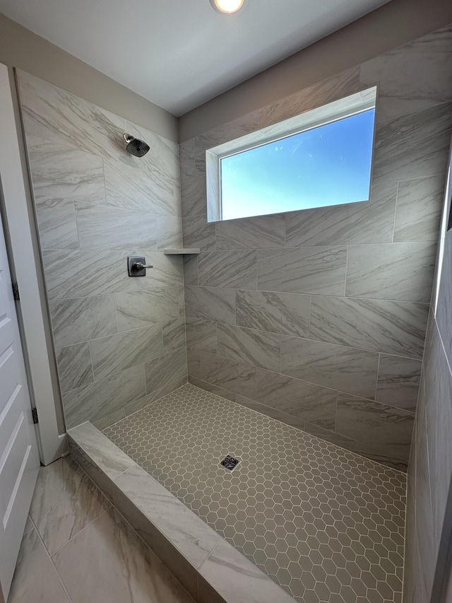 bathroom with a tile shower