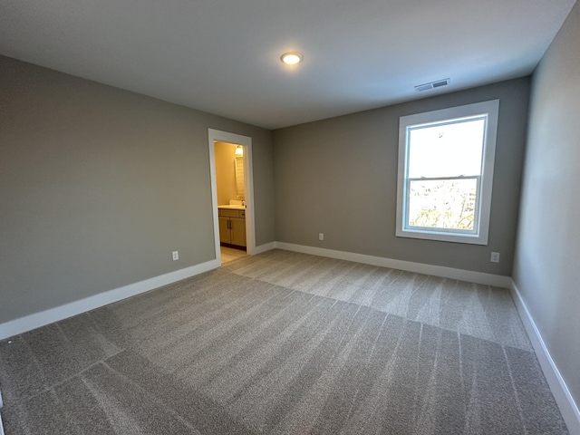 unfurnished room featuring light colored carpet