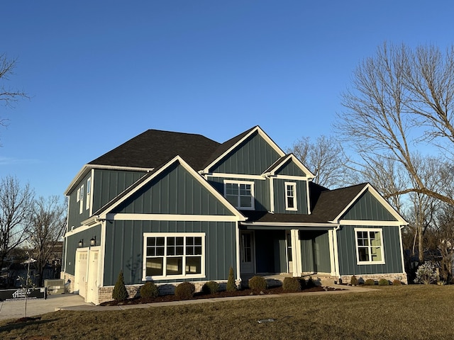 craftsman-style home with a garage and a front yard