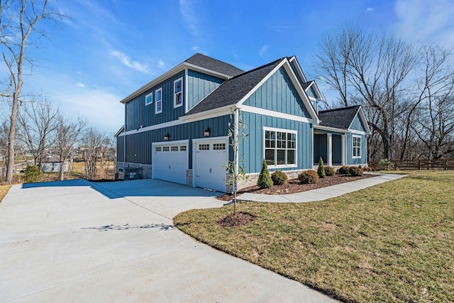 view of side of home featuring a garage, a shingled roof, concrete driveway, a lawn, and board and batten siding