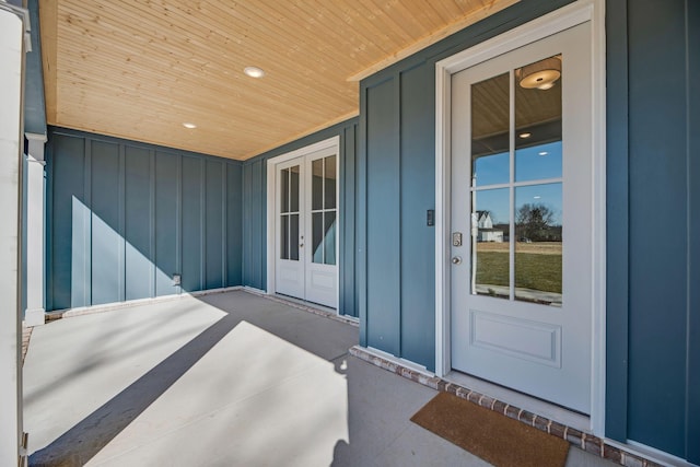 entrance to property featuring board and batten siding and french doors