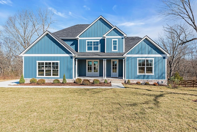 craftsman house with roof with shingles, french doors, board and batten siding, and a front yard