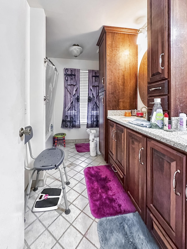 bathroom featuring tile patterned flooring and vanity