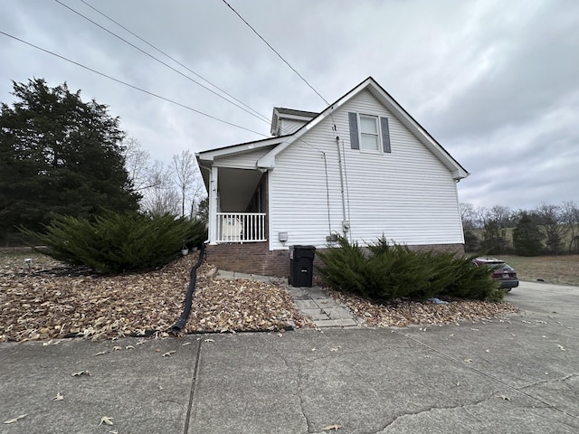 view of side of home with a porch