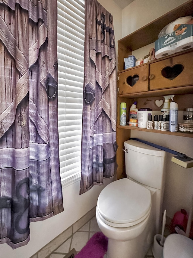 bathroom featuring tile patterned floors and toilet