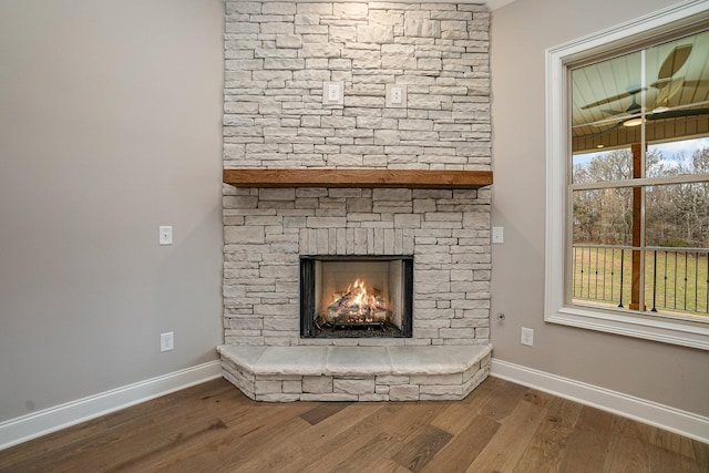 interior details featuring wood-type flooring and a fireplace