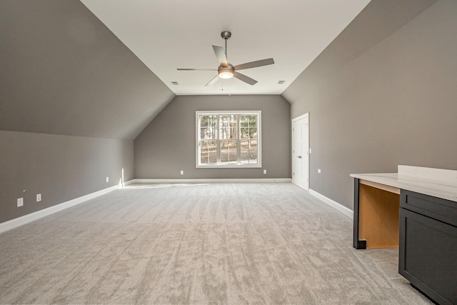 bonus room featuring ceiling fan, lofted ceiling, and light carpet