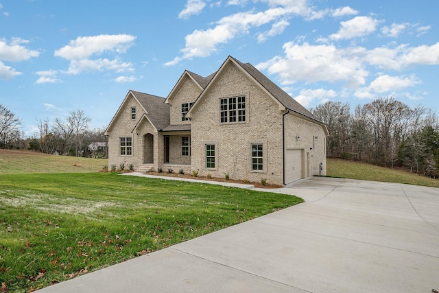 view of front of property with a front yard and a garage