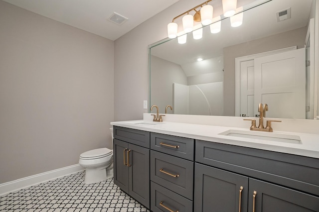 bathroom with vanity, toilet, and walk in shower