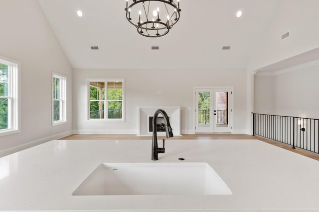 interior space featuring a chandelier, pendant lighting, a healthy amount of sunlight, and sink