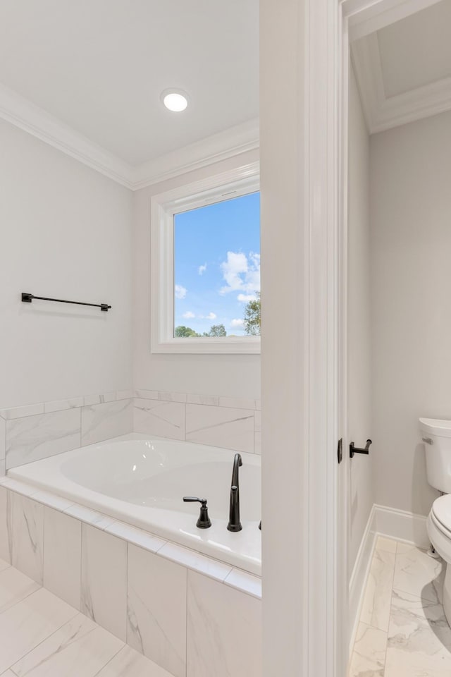 bathroom with toilet, a relaxing tiled tub, and ornamental molding