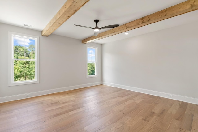 spare room with light wood-type flooring and a wealth of natural light