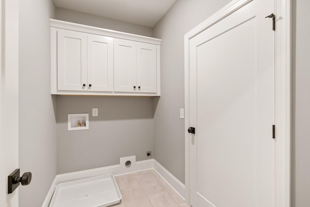 washroom featuring electric dryer hookup, light tile patterned flooring, cabinets, and hookup for a washing machine