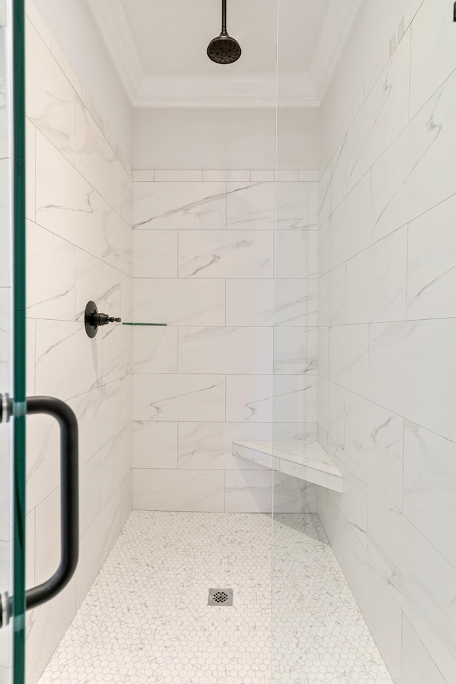 bathroom featuring crown molding and an enclosed shower