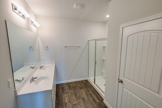 bathroom with vanity, wood-type flooring, and an enclosed shower