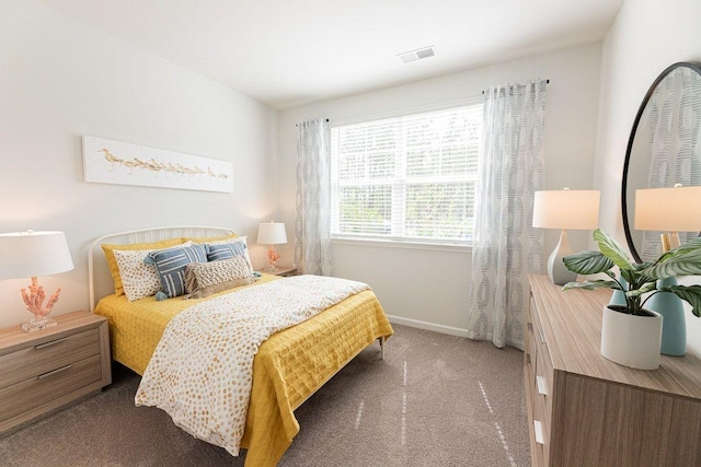 bedroom with dark colored carpet