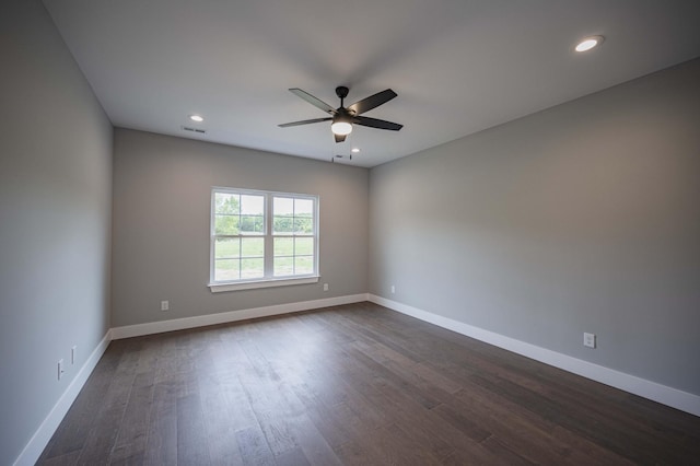 empty room featuring ceiling fan and dark hardwood / wood-style floors