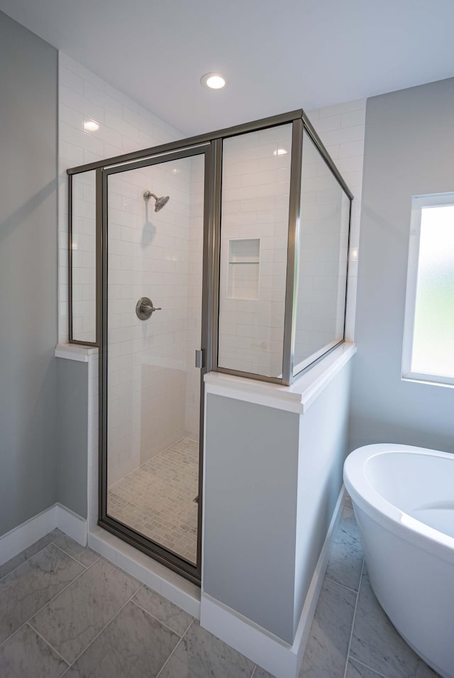 bathroom featuring separate shower and tub