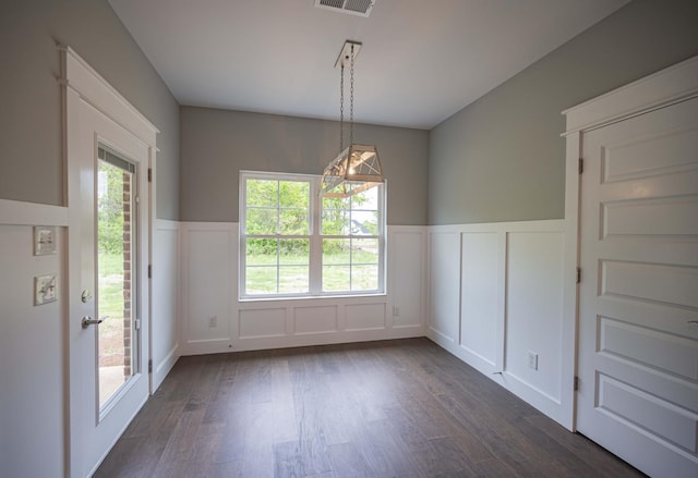 unfurnished dining area featuring dark hardwood / wood-style floors