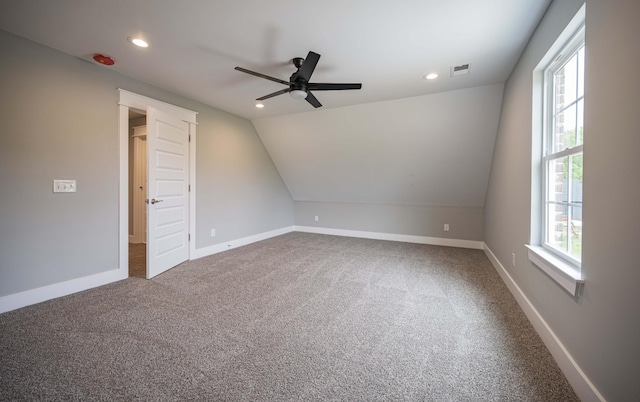 bonus room featuring carpet flooring, lofted ceiling, and a healthy amount of sunlight