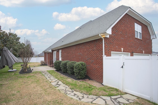 view of home's exterior with a yard