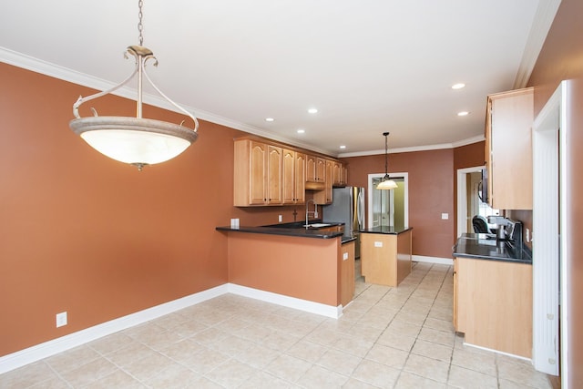 kitchen featuring sink, hanging light fixtures, kitchen peninsula, crown molding, and a kitchen island