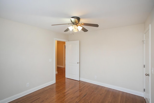 empty room with hardwood / wood-style floors and ceiling fan