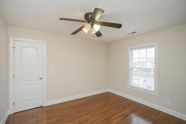 spare room with hardwood / wood-style flooring and ceiling fan