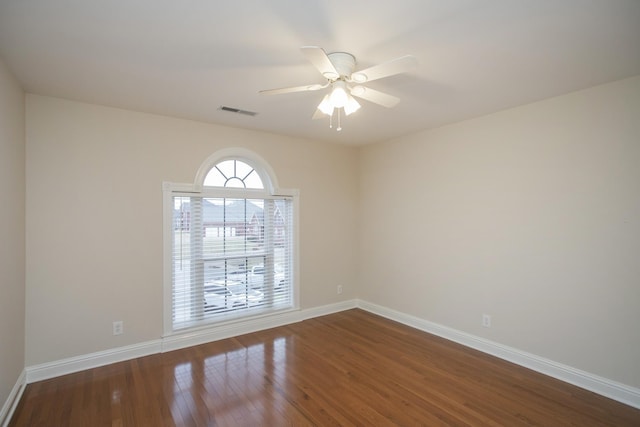 spare room with ceiling fan and wood-type flooring