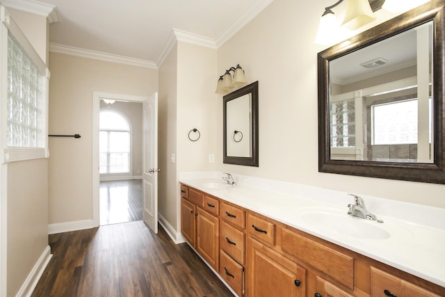 bathroom with hardwood / wood-style floors, vanity, and crown molding