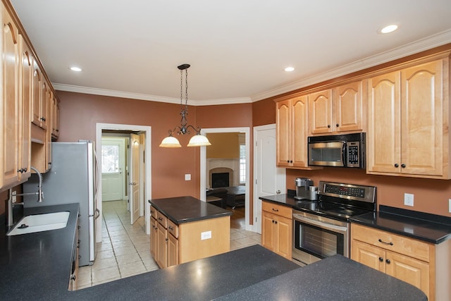 kitchen with a center island, light tile patterned floors, stainless steel appliances, and ornamental molding